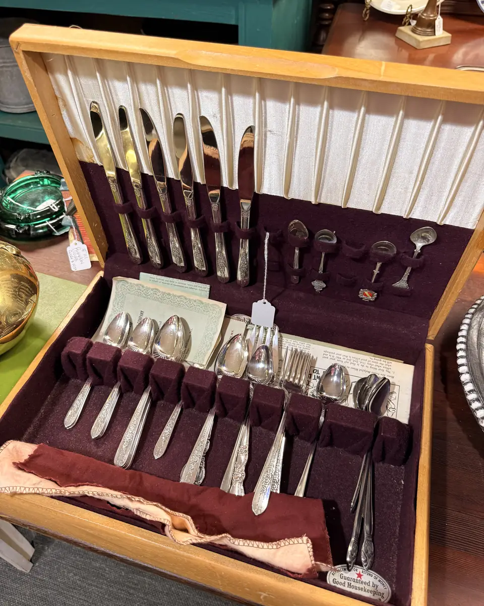 Flatware place settings arranged inside a fitted presentation case at Vintage 72