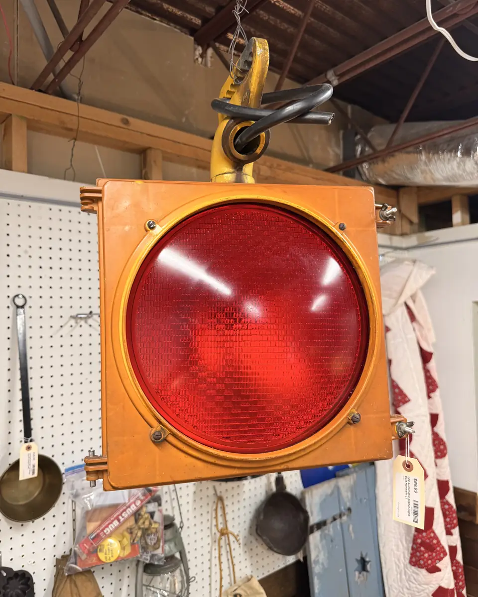 Oversized red signal light with orange square housing hanging at Vintage 72