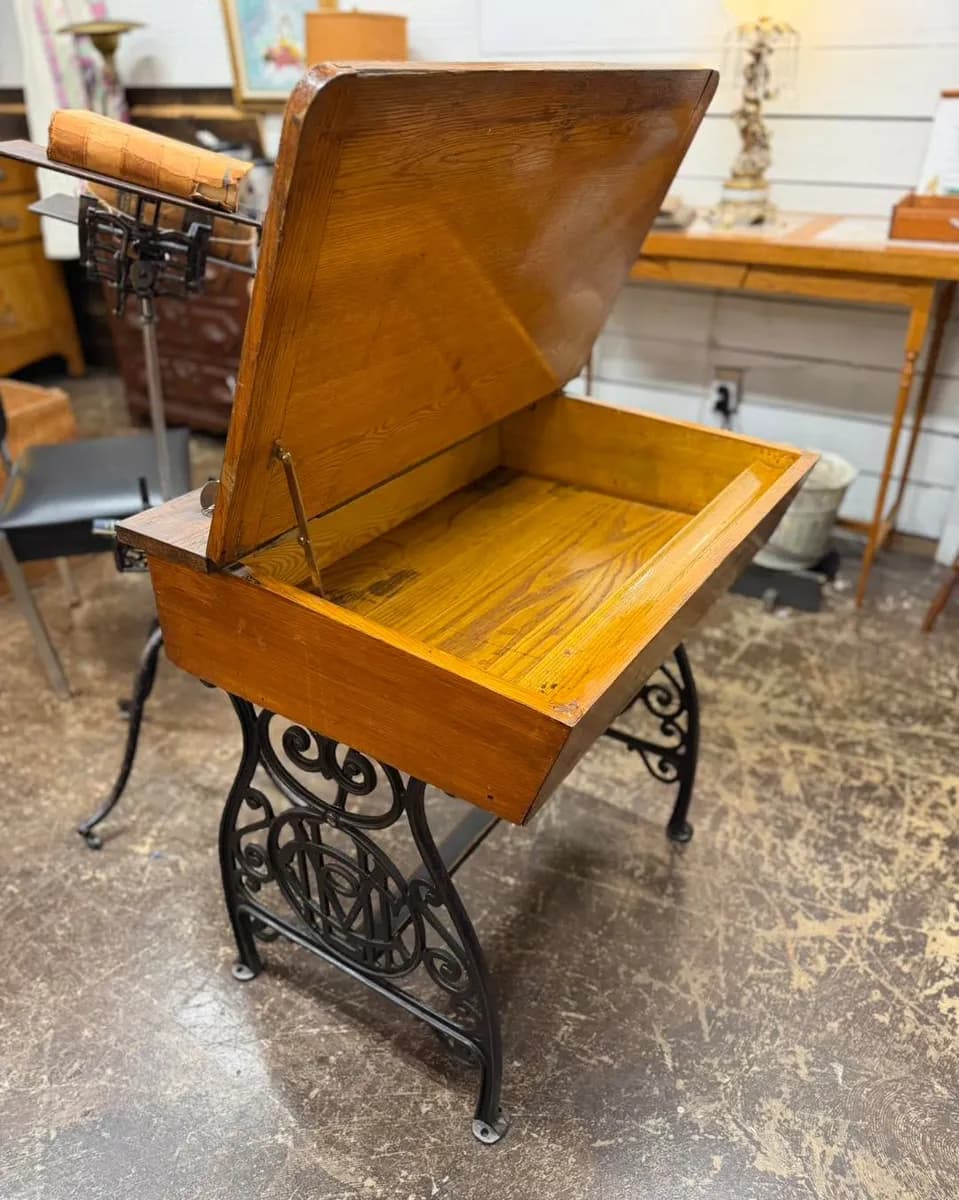 Lift-top MetLife Insurance desk with decorative treadle base at Vintage 72