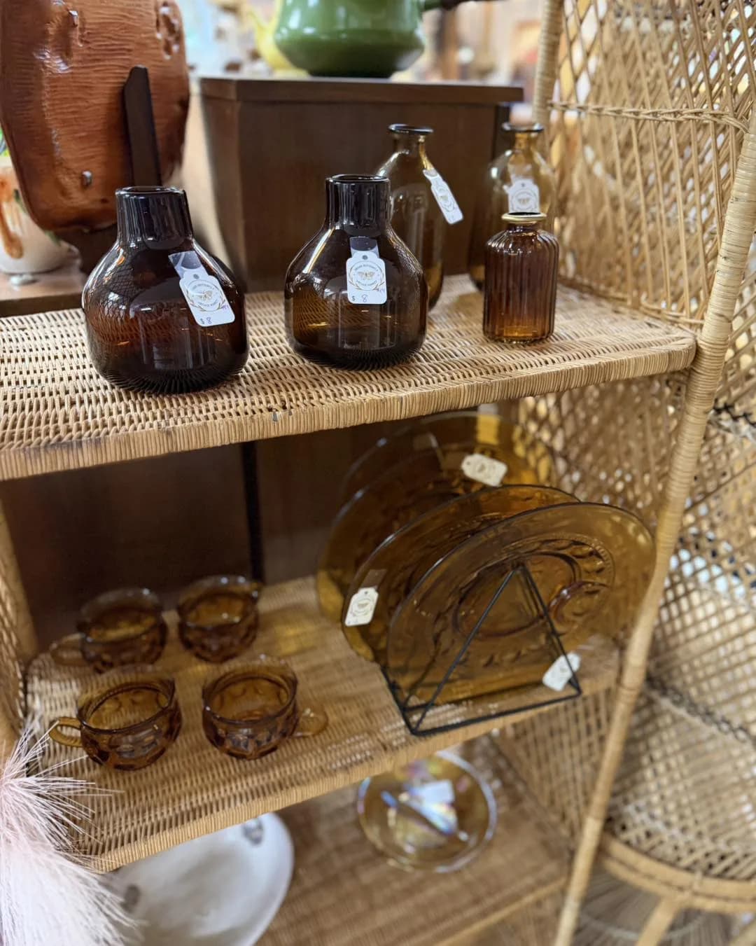 Amber glass bottles and cups arranged in a vendor vignette