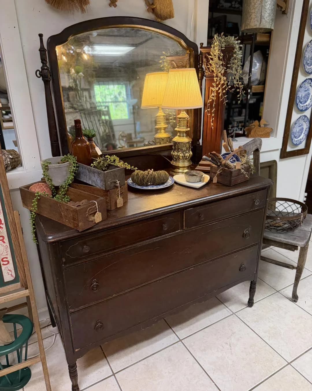 Antique dresser with ornate mirror in a curated vendor booth