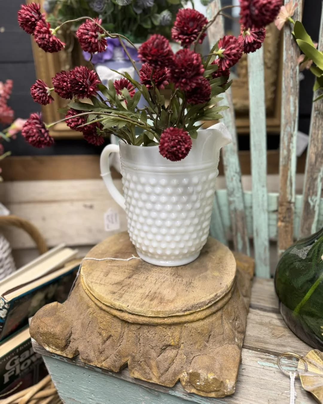 Milk glass pitcher with fresh flowers in a home decor vignette