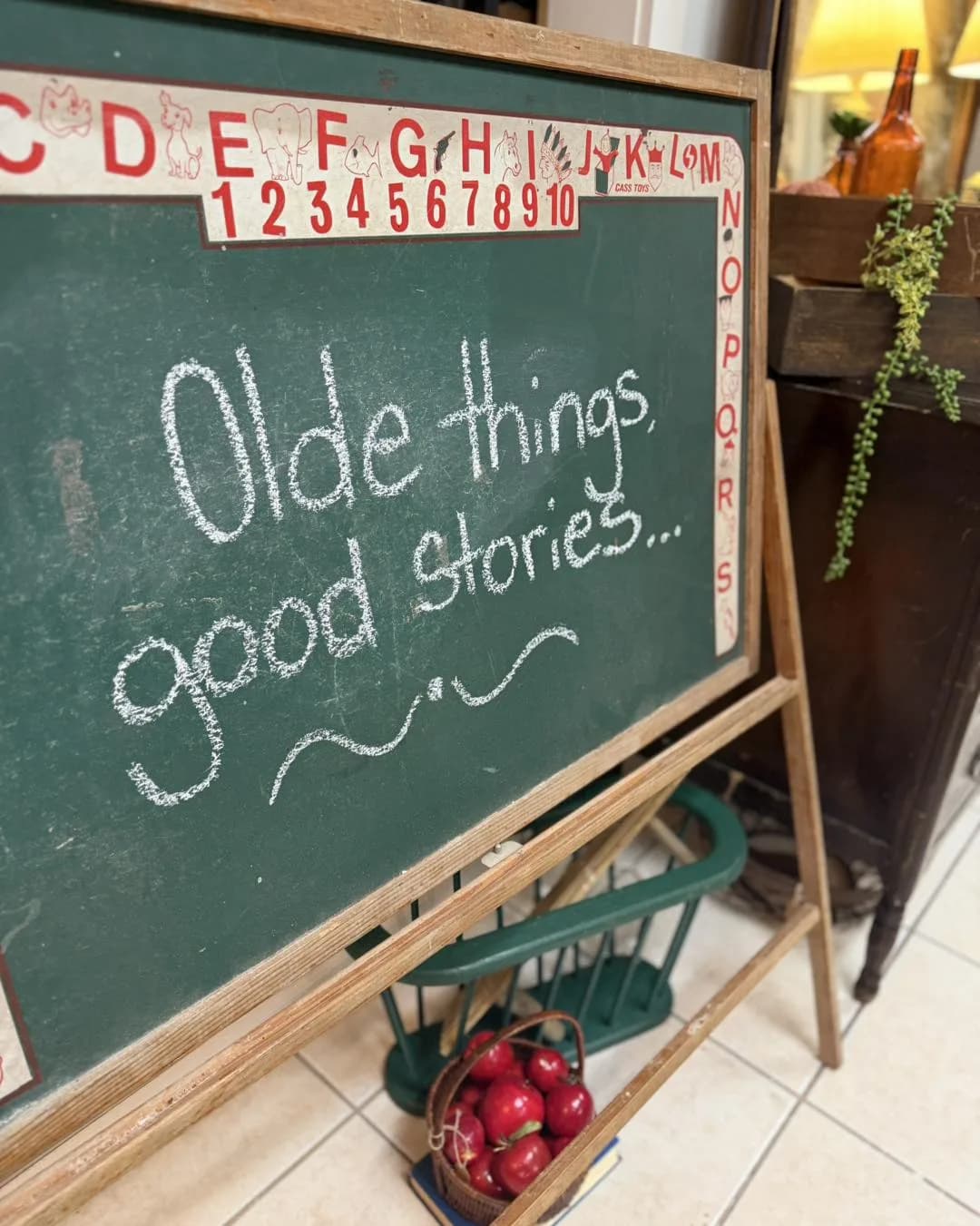 Olde Things Good Stories booth with chalkboard sign and vintage wares