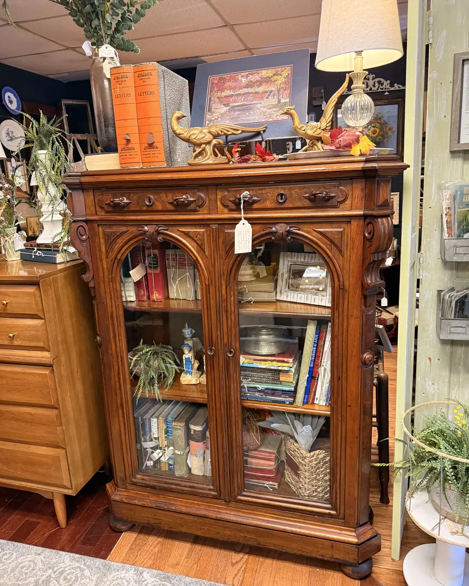 Carved glass-front cabinet with arched doors displayed at Vintage 72