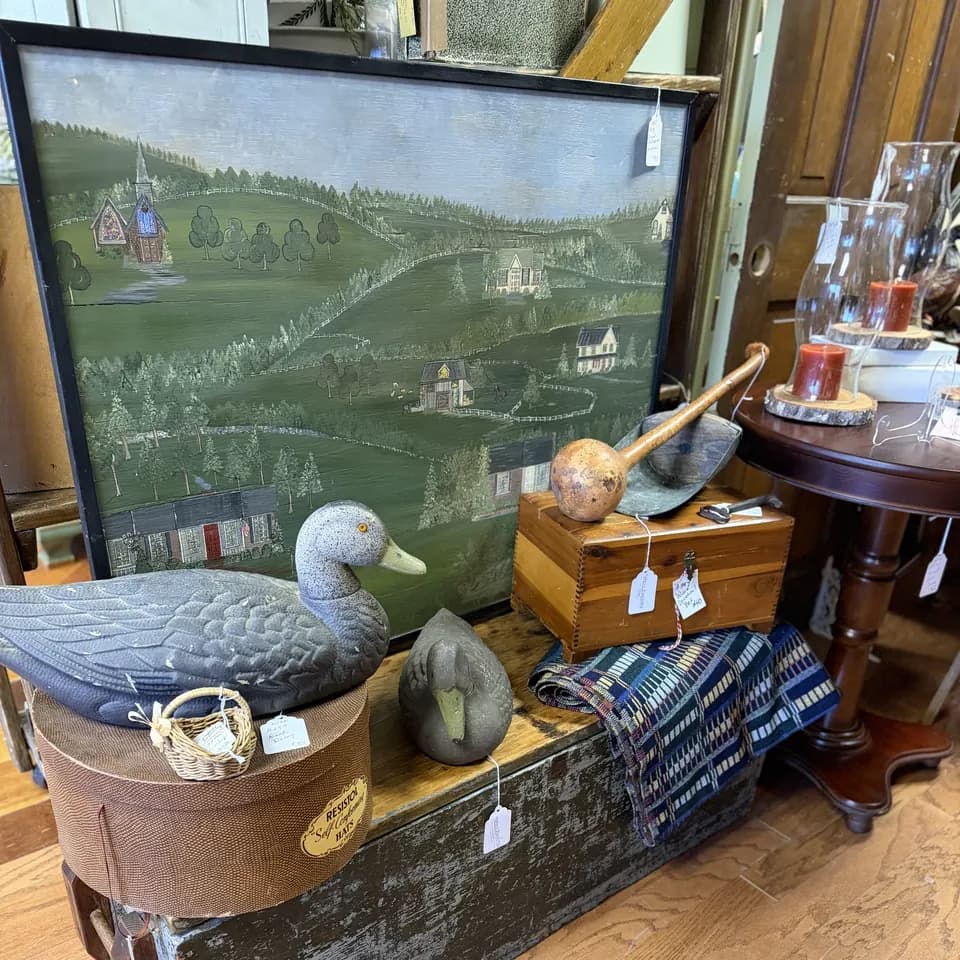 Painted folk-art countryside scene with two duck decoys, a Resistol hat box, and a wooden box at Vintage 72