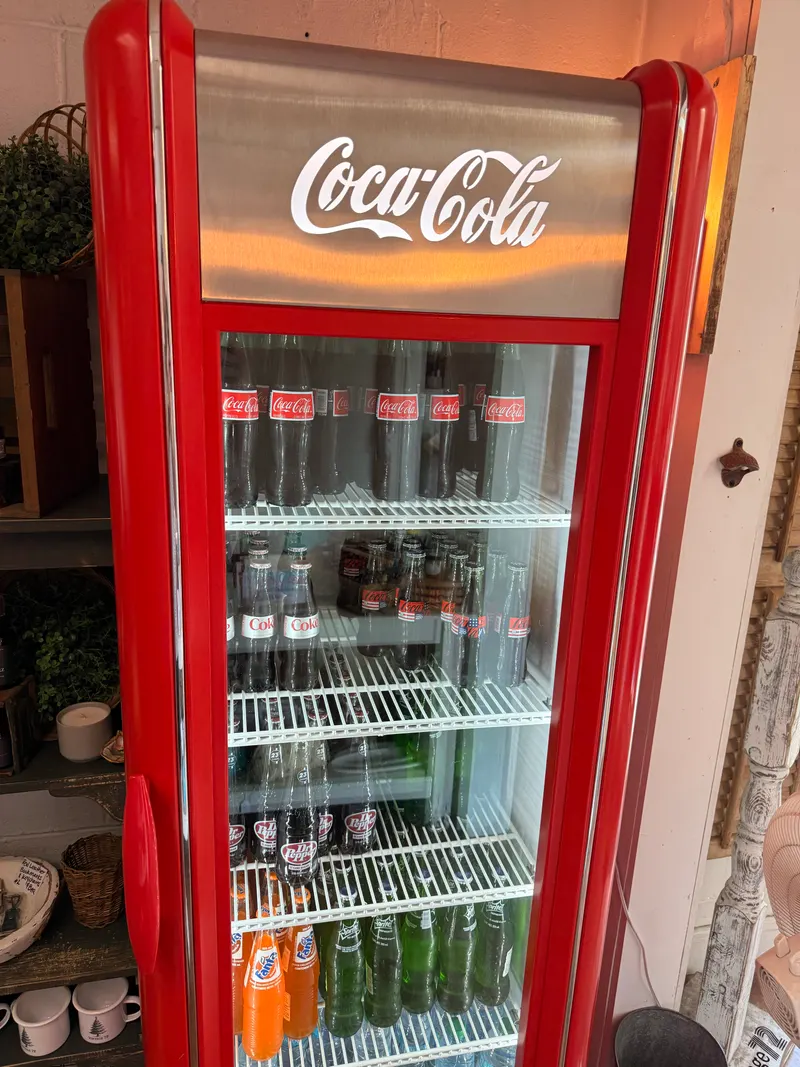 Red Coca-Cola cooler filled with glass-bottle sodas at Vintage 72