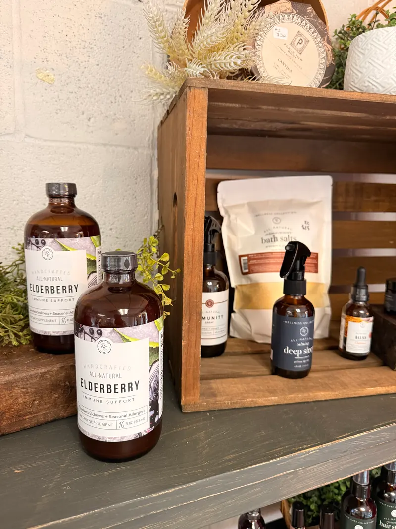 Rowe Casa Organics bottles, bath salts, and body care displayed on wooden shelves at Vintage 72